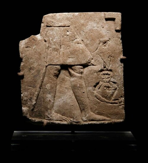 An Egyptian Limestone Sculptor's Model or Votive Relief
