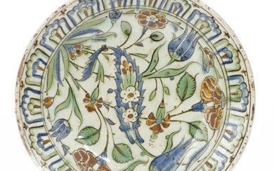 An Iznik pottery dish decorated in raised-red, cobalt blue and green with...