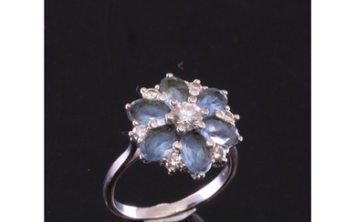 An aquamarine and diamond daisy cluster ring set in 18ct gol...