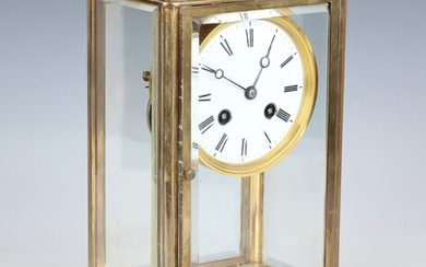 An early 20th century French brass cased four glass mantel clock with eight day movement striking on