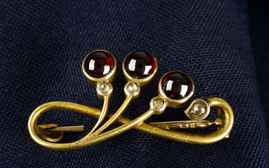 An early 20th century Russian gold garnet and rose-cut diamond stylised floral brooch.