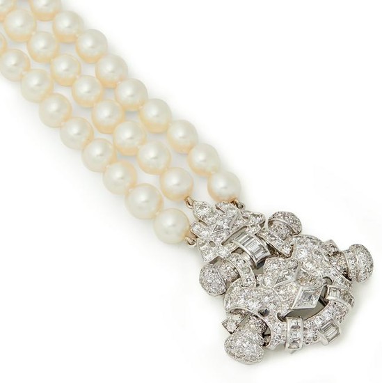 A three-row cultured pearl and diamond bracelet.