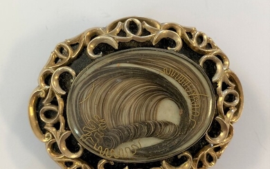 An early Victorian hairwork and black enamel mourning brooch