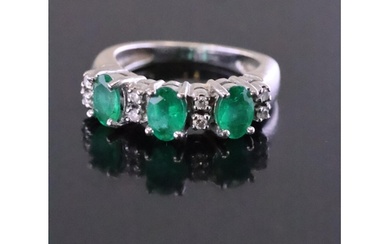 An emerald and diamond cluster ring finger size J Half