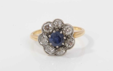 Antique sapphire and diamond cluster ring with a flower head cluster centred with a round mixed cut blue sapphire measuring approximately approximately 5.2mm diameter surrounded by seven old cut di...