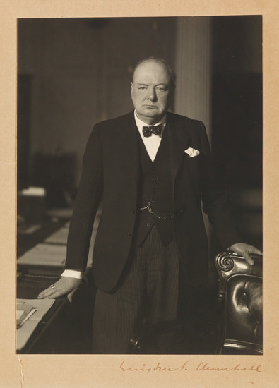 CHURCHILL, WINSTON S. Photograph Signed, 3/4-length portrait by Walter Stoneman, showing him standing...