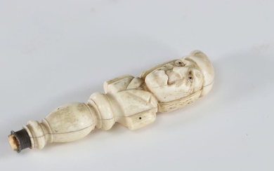 Curiosity handle carved with a grotesque character