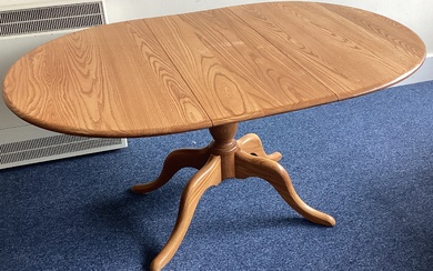 ERCOL: A small oval pedestal dining table. Est. £5