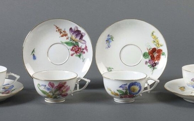 Four cups with Lower Meissen, 1860-1924, porcelain, glazed and decorated with onglaze painting in form of polychrome bouquets and scattered flowers, rims and handles gilded, the bottom of each cup with underglazed blue knob sword mark with two...