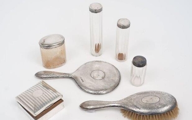 Four silver mounted vanity jars, London, 1911, WG, together with a square silver cigarette box, Birmingham, 1922, maker's mark rubbed, the box with striated design to lid, 8.5 x 8.5cm; and a silver mounted hairbrush and hand mirror, Birmingham...