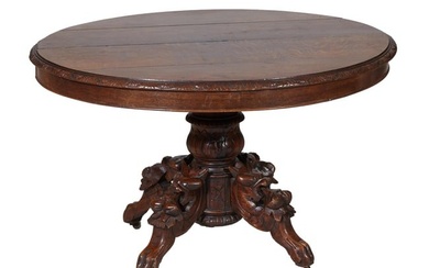 French Henri II Style Carved Oak Center Table, 19th c., the carved stepped oval top atop aa large