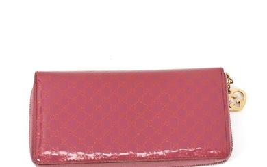 NOT SOLD. Gucci: A wallet made of purple coated monogram canvas with gold toned hardware,...