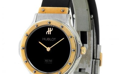 HUBLOT MDM watch. Case in steel and 18kt yellow gold. Circular black dial with spearhead hands and
