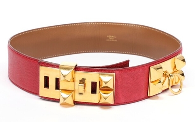 NOT SOLD. Hermès: A belt made of red leather with gold toned buckles and brown...