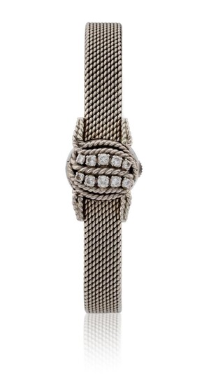 Jaeger-LeCoultre. A lady's 18ct white gold and diamond-set concealed back-winding cocktail watch, c.1960, the circular silvered dial with baton hour markers, back winding Jaeger-LeCoultre MVT, the hinged cover set with two rows of brilliant-cut...