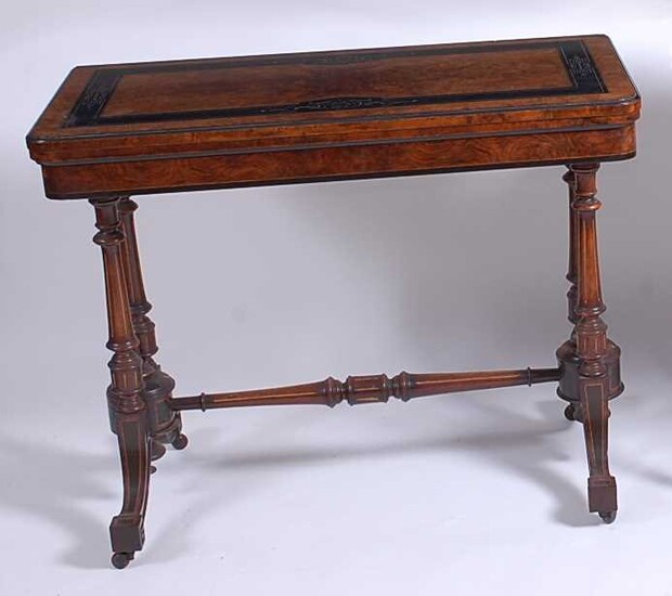 A Victorian Aesthetic Movement figured walnut and ebonised card table