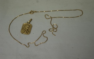 Lot in 18 kt yellow gold including a religious medal and a chain (broken, sold for scrap). Weight 3,48 g