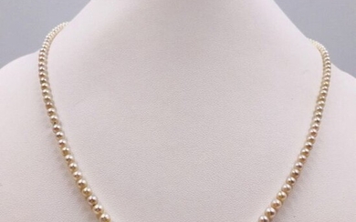 NECKLACE made up of a row of one hundred and twenty-three round cultured pearls in chutes, certified by the Laboratoire Français de Gemmologie as being cored and of seawater origin. The ovoid ratchet clasp in 750 thousandths white gold and secured...