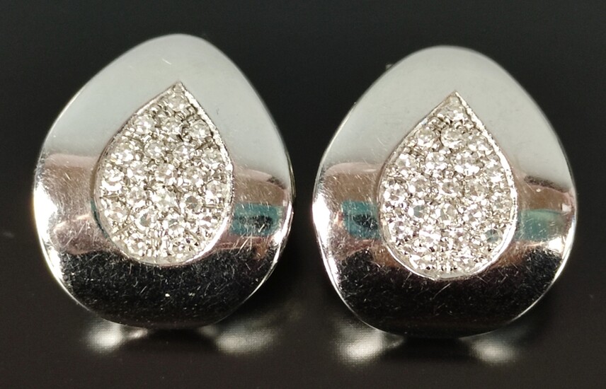 Pair of earclips, triangle shape with rounded corners, each centered with diamonds, 750/18K white g