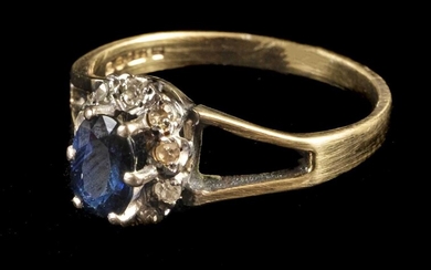 Ring. An 18ct gold sapphire and diamond cluster ring