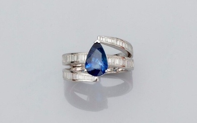 Ring in white gold, 750 MM, set with a pear-cut sapphire, beautifully coloured, weighing 2.55 carats and carried by a succession of rails of baguette-cut diamonds, total approximately 1 carat, size: 55, weight: 9.64gr. rough.
