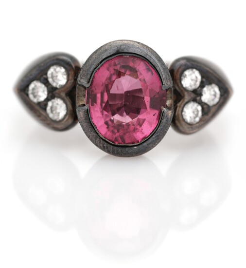 NOT SOLD. Stenstrup Juveler: A rhodolite and diamond ring set with a rhodolite flanked by...