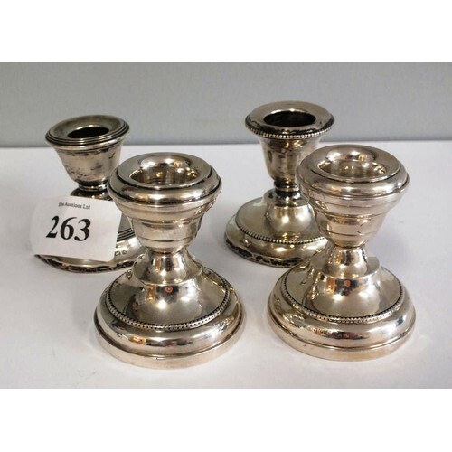 TWO PAIRS OF STERLING SILVER SQUAT CANDLESTICKS WITH WEIGHTE...