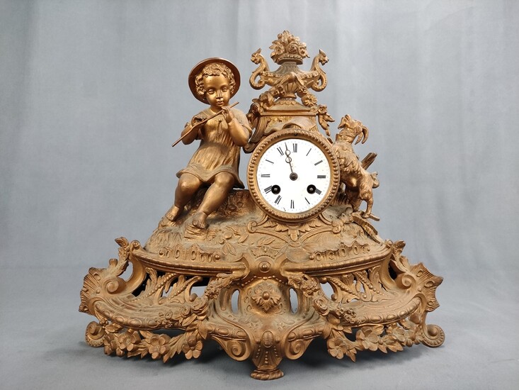 Table clock/chimney clock with boy playing the flute, goat to the left, body decorated with floral