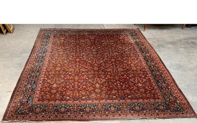 Tappeto Keshan, Persia, secolo XX. Annodato in lana Manchester con decoro millefleur su fondo rubino (cm 406x310) (lievi difetti)