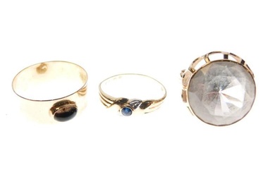 Three assorted yellow metal rings comprising a broad band...