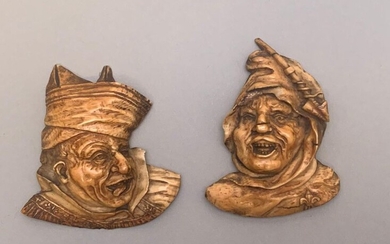 Two sconce medallions depicting two grotesque heads. Germany. 19th century.