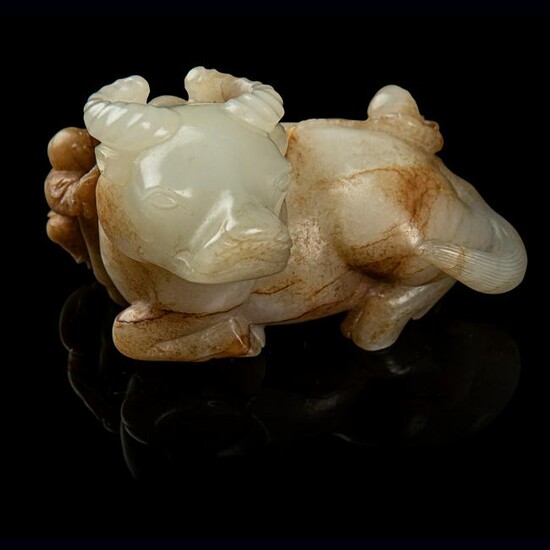 WHITE JADE WITH RUSSET SKIN CARVING OF A BUFFALO WITH