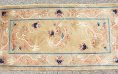 A CHINESE WOOL RUG with Dragon design in blue and
