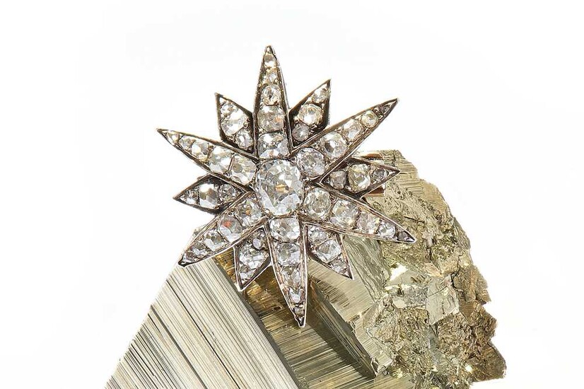 A diamond star brooch, circa 1880 The twelve-ray star...