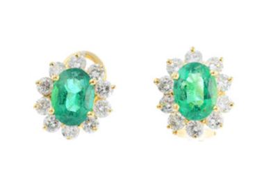 A pair of emerald and diamond cluster earrings. View more details