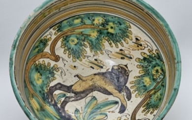 GRANDE COUPE Creuse en faïence à décor polychrome d'un ours dans un paysage. Restauré et agrafé. Diam. : 34,5 cm, Haut. : 20,5 cm.