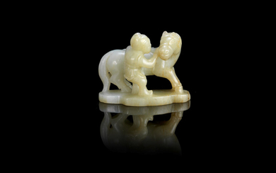 A pale celadon jade carving of a horse and groom