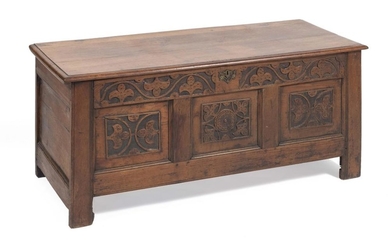 JACOBEAN-STYLE LIFT-TOP CHEST In oak. Front panels carved with vining leaves. Interior with ditty box. Height 22.5". Width 50". Dept...