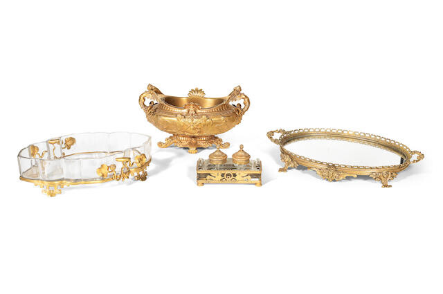 A late 19th century / early 20th century French gilt bronze jardinière, and three similar period gilt bronze mounted pieces comprising a mirrored tray, a glass oval dish and a glass inkwell