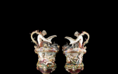 A pair of polychrome porcelain ewers. Naples, early 20th century (h. cm 43) (defects and losses)