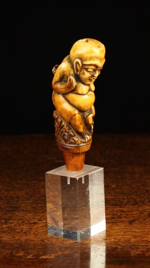 A 19th Century Indonesian Figural Walking Stick Handle carved from mammoth ivory, 4'' (10 cm) in hei