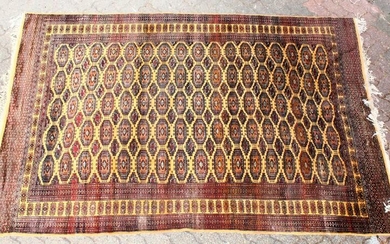 A 20TH CENTURY BOKHARA STYLE CARPET, beige ground with