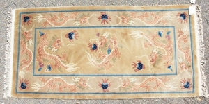 A CHINESE WOOL RUG with Dragon design in blue and