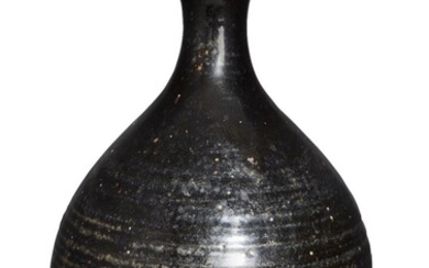 A Chinese black-glazed Cizhou-type stoneware pear-shaped vase,yuhuchun ping, Jin/Yuan dynasty, covered inside and out in a glossy dark brown glaze stopping short of the foot. Provenance: Estate of the late designer Anthony Powell (1935 – 2021). 金/元...