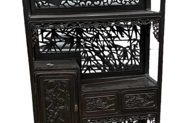 A Chinese carved hardwood and ebonised display cabinet, with two...