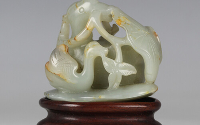 A Chinese celadon jade carving, probably 20th century, carved and pierced as a mandarin duck and duc