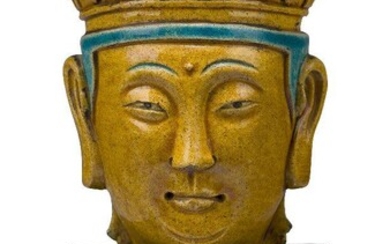 A Chinese stoneware sancai glazed head of Maitreya, 17th/18th century, modelled with long earlobes, serene expression, and wearing a diadem moulded with deities, inscribed yun (cloud) to the reverse, 28cm high