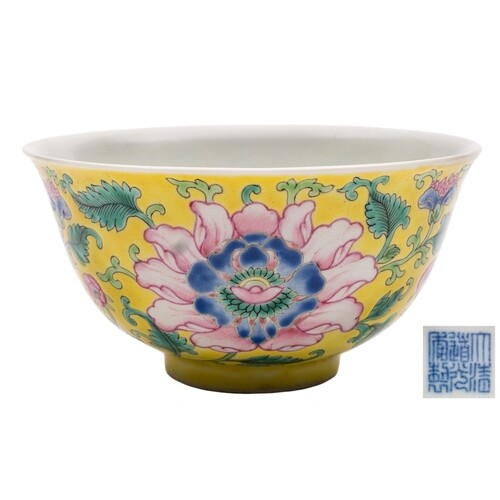 A Chinese yellow-ground famille rose 'peony' bowl: finely en...