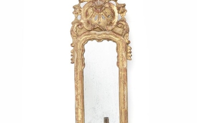 NOT SOLD. A Danish rococo giltwood openwork carved mirror with one brass candle holder. Mid-18th century. H. 72 cm. W. 25 cm. – Bruun Rasmussen Auctioneers of Fine Art