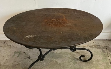 A French style round decorative garden table with scrolling ...